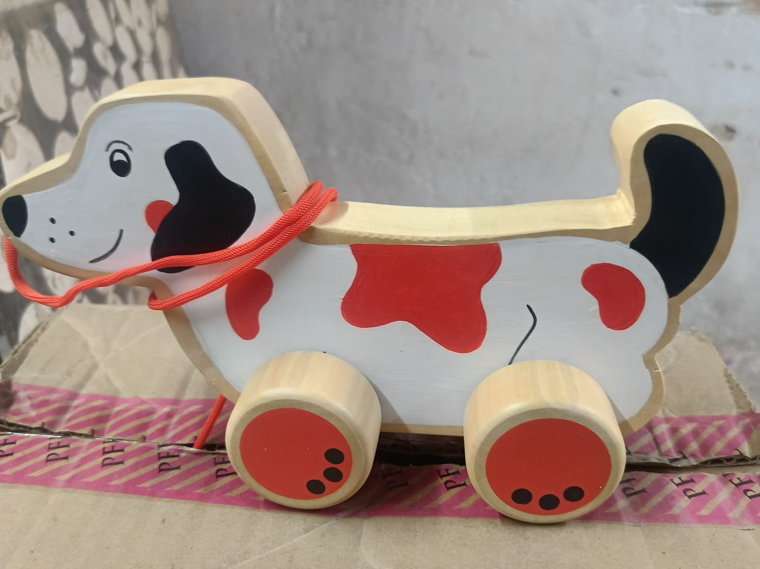 Wooden pull-along spotted dog toy